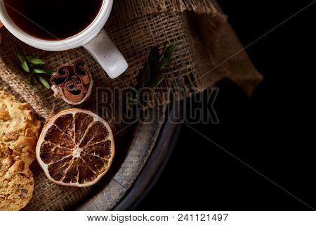 Conceptual Festive Composition With A Cup Of Hot Tea, A Large Set Of Cookies, Cinnamon Sticks Bunch 