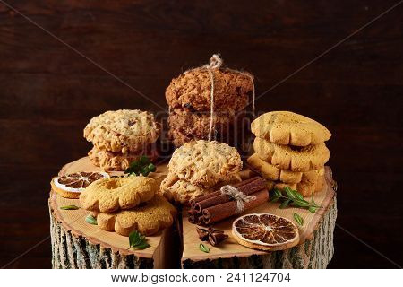 Christmas Concept With Asoortment Of Delicious Sweet Cookies, Cinnamon Sticks Bunch, A Couple Of Dri