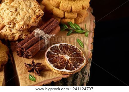 Christmas Concept With Asoortment Of Delicious Sweet Cookies, Cinnamon Sticks Bunch, A Couple Of Dri