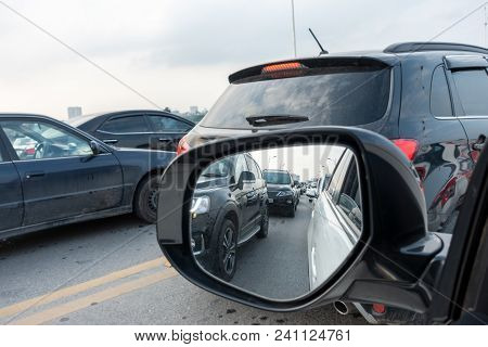 Reflection Of Traffic Flow In Left Side Rear View Mirror At Rush Hour