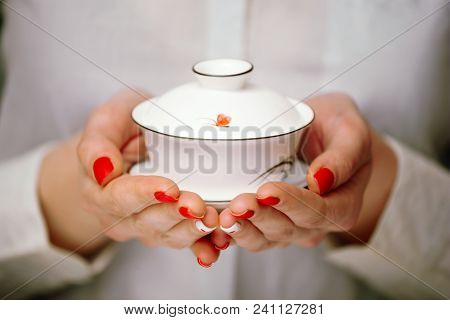 Cropped Shot Of Woman Holding Porcelain Chawan In Front Of The Camera.