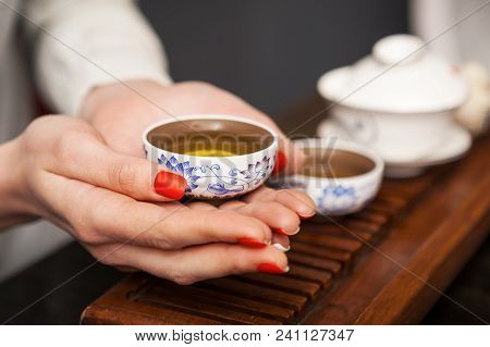 Cropped Shot Of Woman Holding Chawan With Green Oolong.