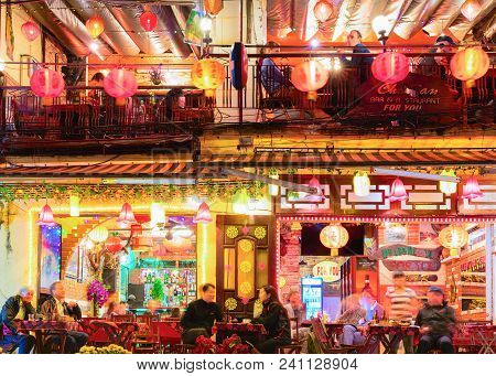 Hoi An, Vietnam - February 17, 2016: People At The Street Restaurant In Hoi An, Vietnam. Late In The