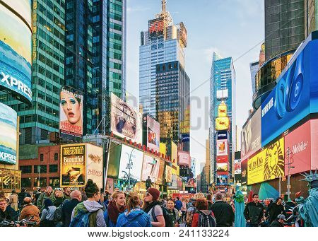New York, Usa - April 26, 2015: People On Times Square On 7th Avenue And Broadway. Skyscrapers In Mi