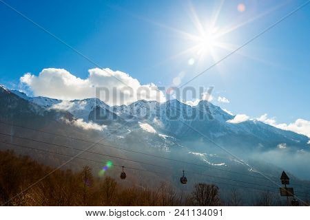 View Of The Mountains Sun And Sky With Funiculars
