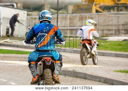 Biker Is Rides On His Colorful Sport Motorcycle On Summer Street. Man Wearing Protective For Bikers.