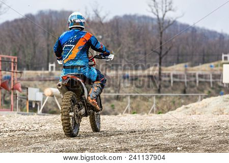 Biker Is Rides On His Colorful Sport Motorcycle On Summer Street. Man Wearing Protective For Bikers.