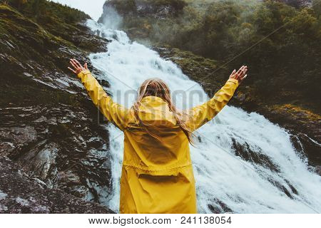 Happy Woman Enjoying Waterfall View Traveling Into The Wild Adventure Lifestyle  Traveler Wearing Tr