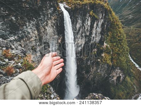 Traveler Hand Showing Waterfall Travel In Norway Vettisfossen Landscape Aerial View Mountains Advent