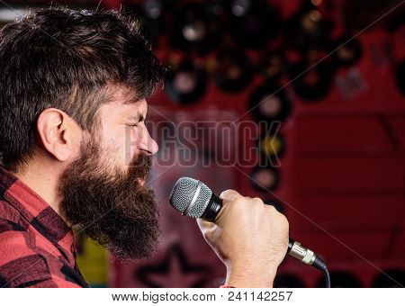 Musician With Beard And Mustache Singing Song In Karaoke. Punk Rock Concept. Man With Tense Face Hol