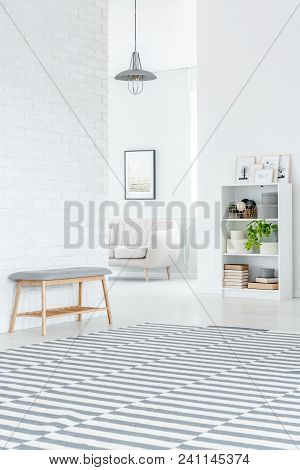 Gray Bench Against Brick Wall
