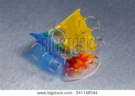 Colorful Dental Braces Or Retainer For Teeth On Metall Background, Closeup