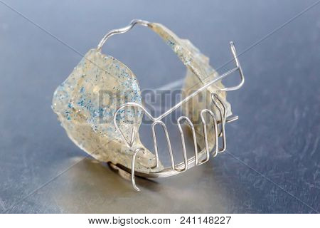 Gray Dental Braces Or Retainer For Teeth On Metall Background, Closeup
