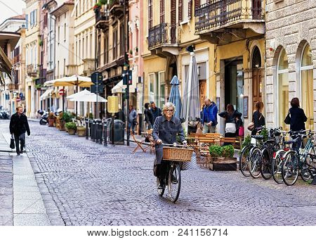 Mantua, Italy - October 22, 2016: Woman On Bicycle In The Old City Center Of Mantua, Lombardy, Italy