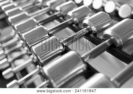 Rows Of Dumbbells In The Gym With Hign Contrast Light