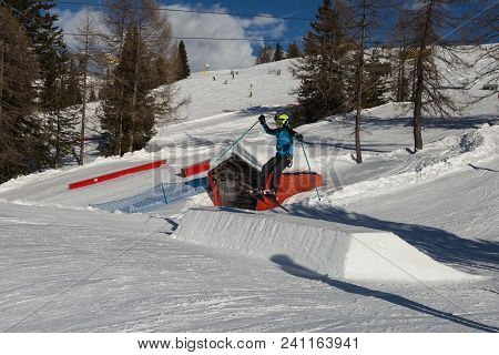 Skier In Action: Ski Jumping In The Mountain Snowpark.