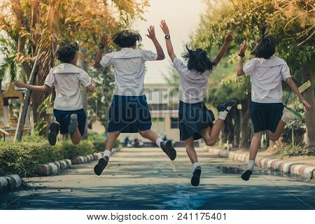 Group Of Friends Having Fun On Street In Primary School.
