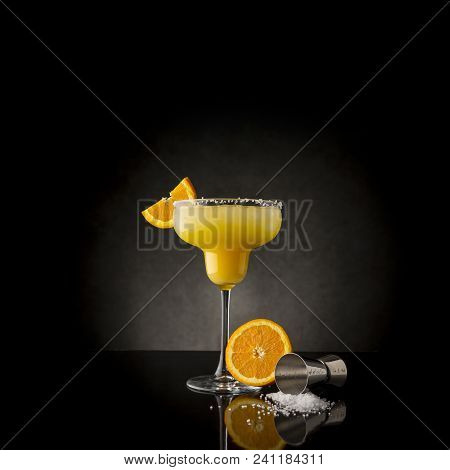 Orange Margarita Cocktail With Tequila, Triple Sec, Orange Juice, Crushed Ice And Some Salt On The R
