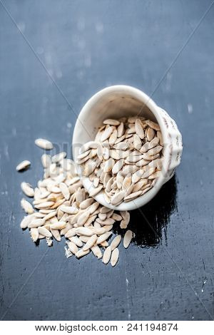 Edible Dried Raw Organic Seeds Of Musk Melon Or Cantaloupe Or Tati Or Honeydew On A Wooden Surface.