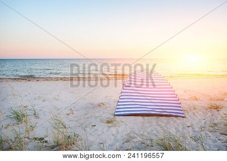 Tents On Beach Of White Sandunder Blue Sky