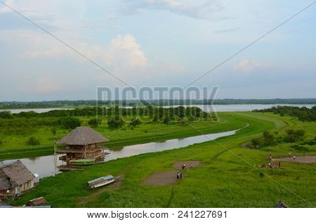IQUITOS, PERU - OCTOBER 17, 2015: People gather in an area of Iquitos, to play sports and picnic, at low water season along the banks of the Amazon River.