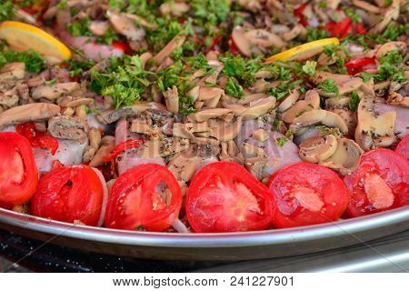 Big Pan Of Andouillettte Dish With The Vegetables On A French Market