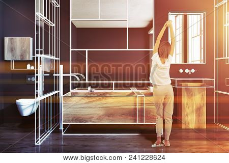 Futuristic Luxury Bathroom Interior With Black Walls, A Wooden Bathtub, A Mirror And A Glass Wall. A