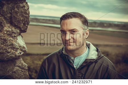 A Tourist Posing For A Photo By The Ancient Walls Of Hadleigh Castle, Uk