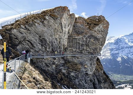 Traveller Are Walking On Sky Cliff Walk At First Peak Of Alps Mountain , Grindelwald Switzerland