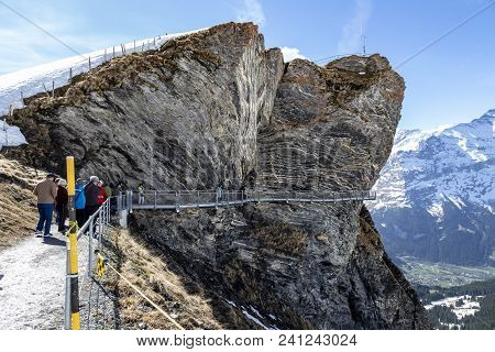 Traveller Are Walking On Sky Cliff Walk At First Peak Of Alps Mountain , Grindelwald Switzerland