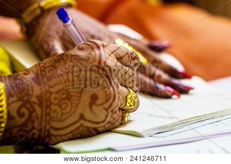 A Newly Married Indian Bengali Wife With Golden Wedding Ring Signing Marriage Registration Form