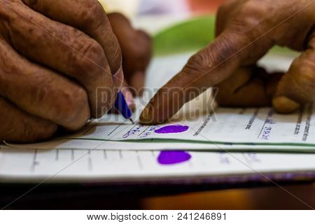 Old Man Signing On An Imoirtant Legal Document As Instructed