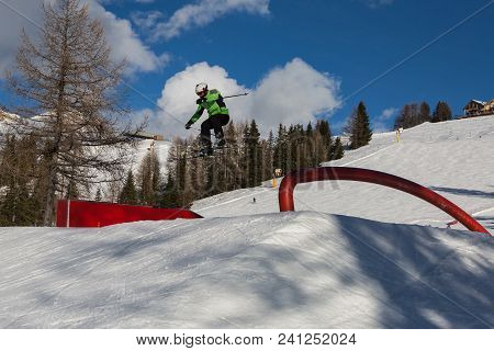 Skier In Action: Ski Jumping In The Mountain Snowpark.