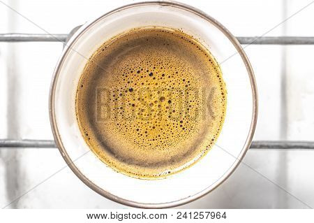 Cream Of Coffee On Top Of A Warm Color