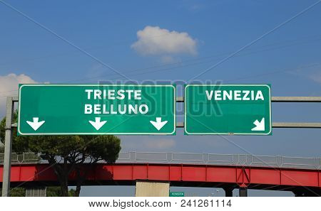 Green Highway Sign In Italy Indicating The Road To Venice Belluno And Trieste