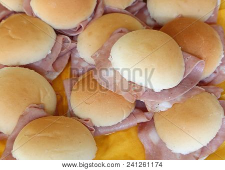 Round Milk Sandwiches Stuffed With Ham On A Buffet Table