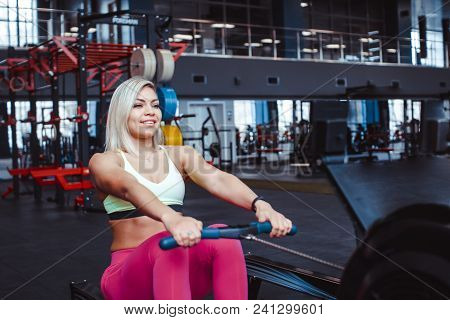 Beautiful Woman Is Doing Exercises In The Sport Club.