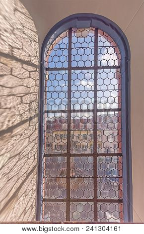 Old Stained Glass Window Of A Church With Shadows