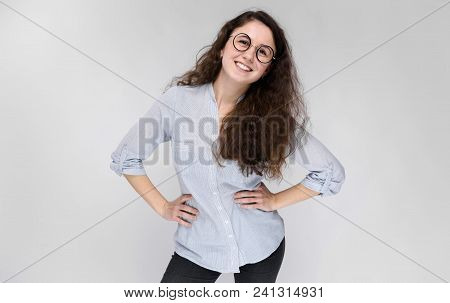 Young Girl Holds Her Hand Glasses. The Girl Is Smiling. The Girl Is Smiling.
