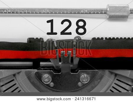 128 Number Text Written By An Old Typewriter On White Sheet
