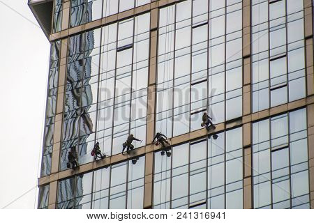 Moscow, Russia - May, 18, 2018: Steeplejacks work on a wall of Moscow city building