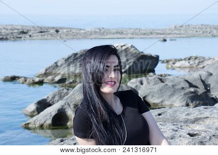 Happy Woman On The Beach. Portrait Of A Beautiful Girl Close-up. Spring Portrait On The Beach. Young