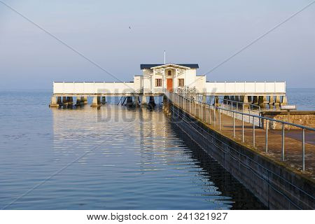 Long Bridge In The Ocean Leading To A Bathhouse In The City Borgholm At Oland, Sweden