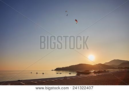 Paraglider Silhouette Flying Over Misty Mountain Valley In Beautiful Warm Sunset Colors - Sport, Act