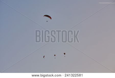 Paraglider Silhouette Flying Over Misty Mountain Valley In Beautiful Warm Sunset Colors - Sport, Act