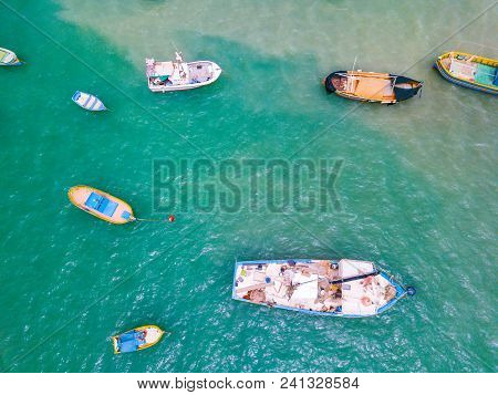 Traditional Eyed Colorful Boats Luzzu In The Harbor Of Mediterranean Fishing Village Marsaxlokk, Mal