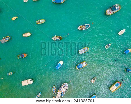 Traditional Eyed Colorful Boats Luzzu In The Harbor Of Mediterranean Fishing Village Marsaxlokk, Mal