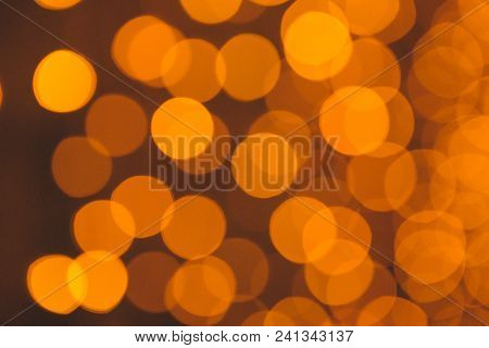 Many Blurred Small Electric Bulbs On A Wall. Yellow Blurred Lights. Wall Of Christmas Lights