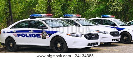 Laval, Canada: May 19, 2018. Police Cars Parked In The Parking Area Of The Public Park. A Lot Of Pol