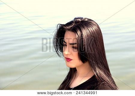 Happy Woman On The Beach. Portrait Of A Beautiful Girl Close-up. Spring Portrait On The Beach. Young